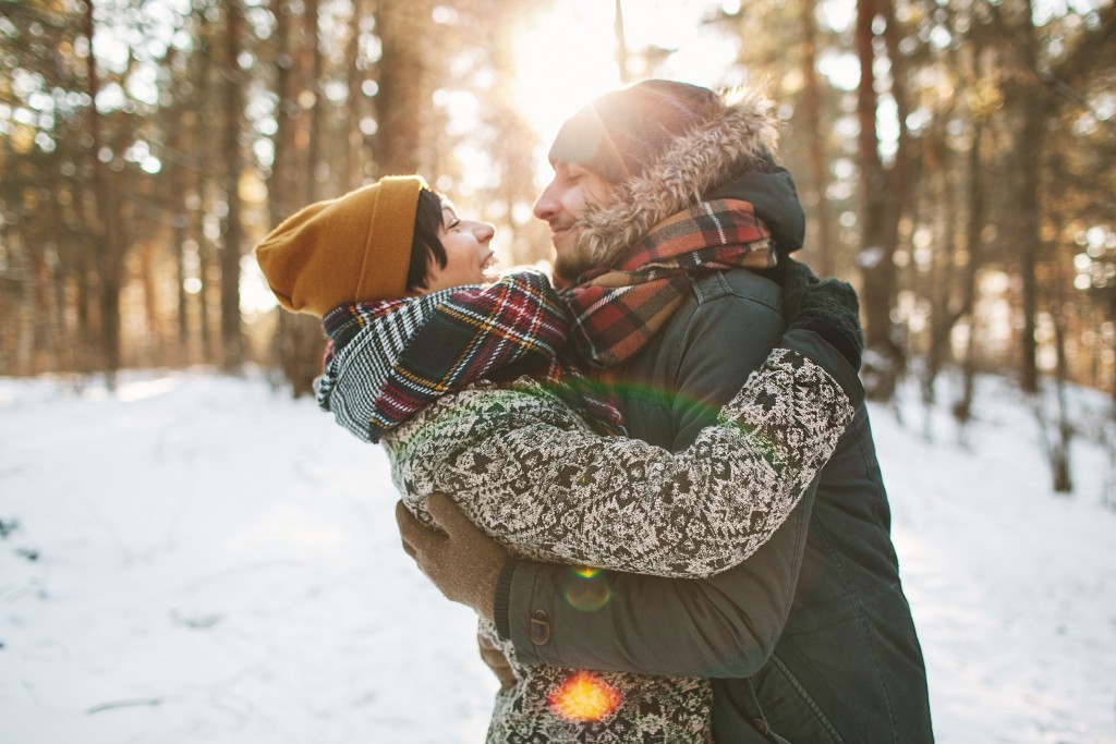 happiness Young hipster couple hugging each other in winter forest