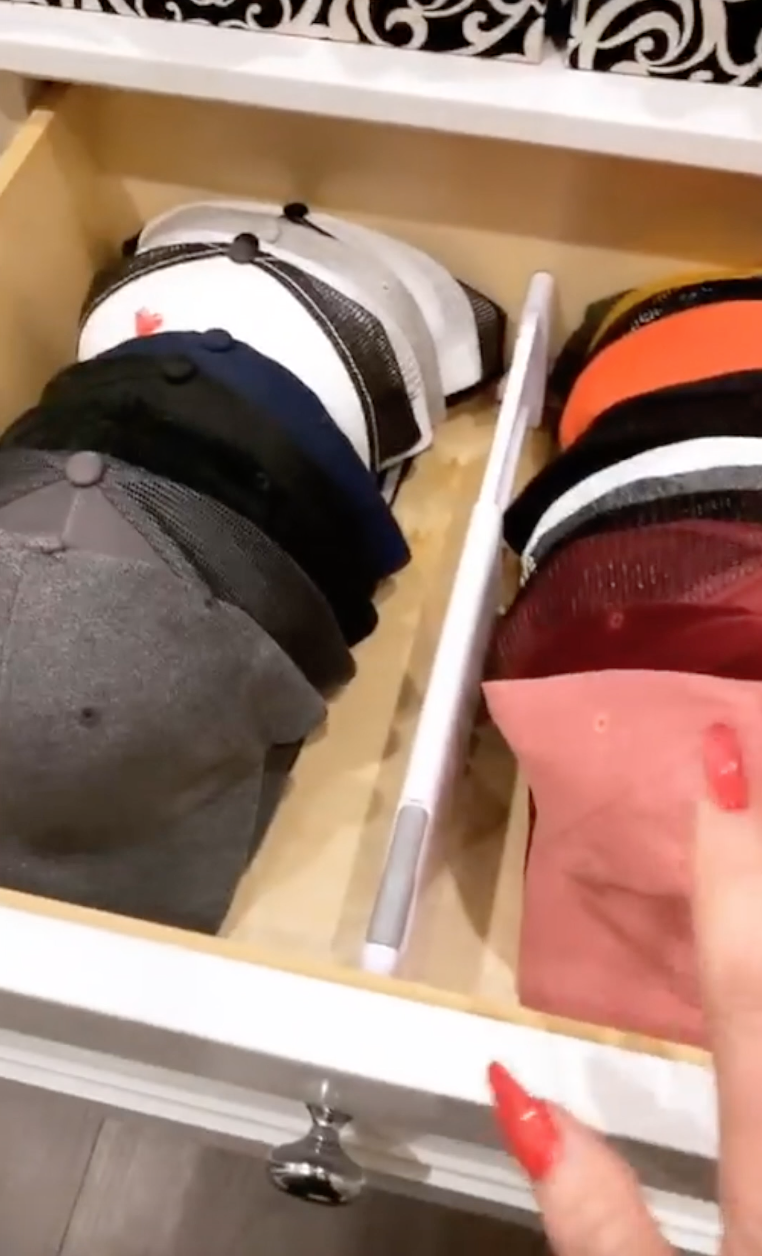 a drawer that has several hats in it